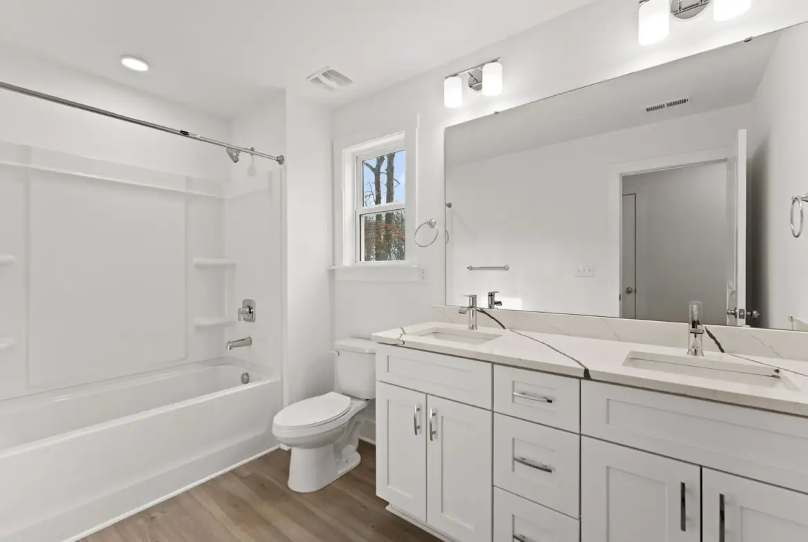 bathroom with tub/shower combo and dual sink vanity at 1906 Rucker Rd