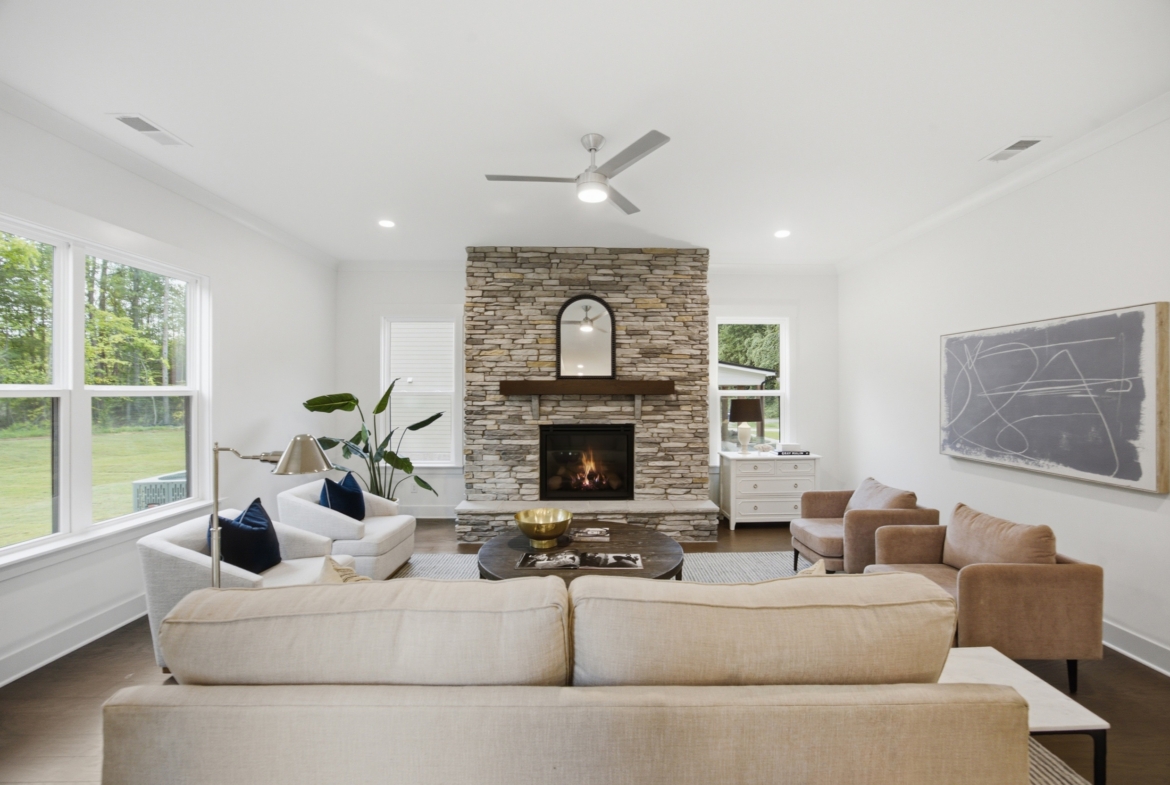 Staged living room with stone fireplace